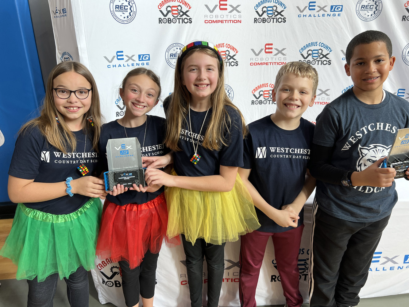 Lower School Robotics teams with trophies